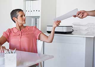 Woman handed papers Jpg